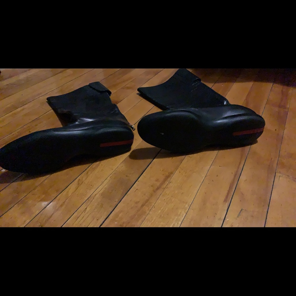 Used mid calf black leather Prada boots. No heel. No box
